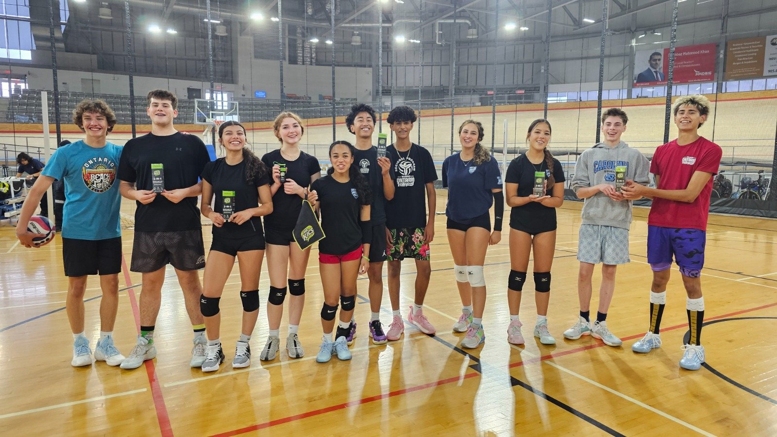 Young volleyball players holding Mr. Kics grip spray