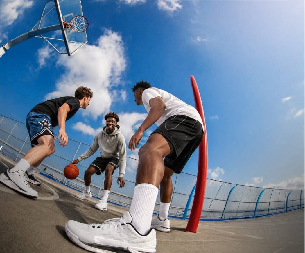 Friends playing basketball on an outdoor court